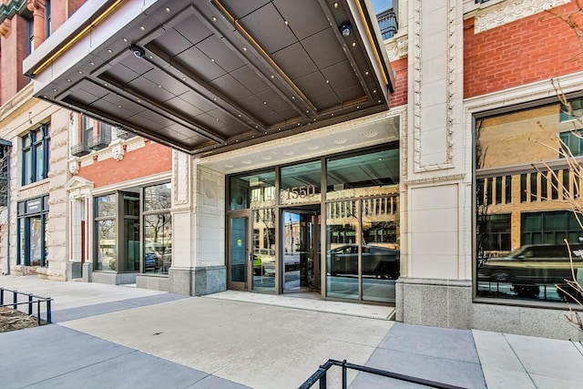 property entrance featuring brick siding