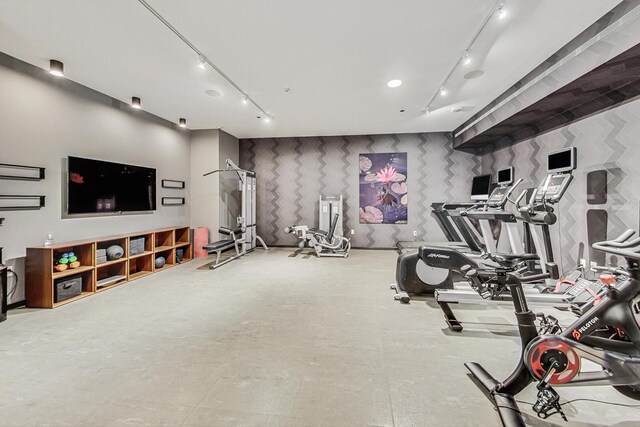 interior space featuring wallpapered walls and rail lighting