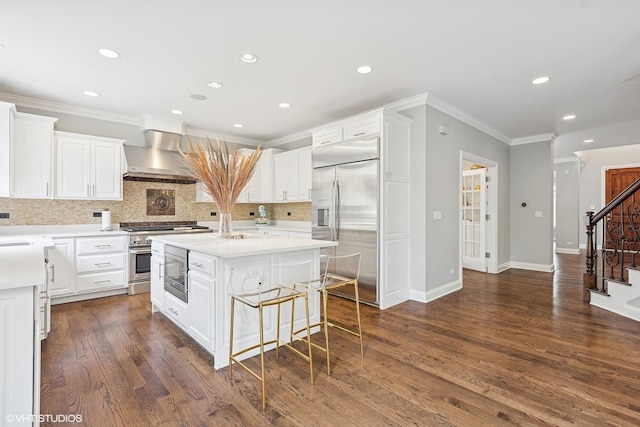 410 W 2nd St, Elmhurst, IL 60126 - kitchen with crown molding, decorative backsplash, built in appliances, wall chimney range hood, and a center island