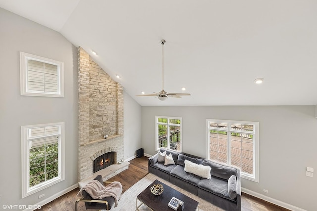410 W 2nd St, Elmhurst, IL 60126 - living area featuring a stone fireplace, ceiling fan, wood finished floors, and vaulted ceiling