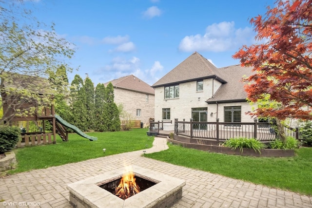 410 W 2nd St, Elmhurst, IL 60126 - back of property featuring a patio, a playground, a yard, and an outdoor fire pit
