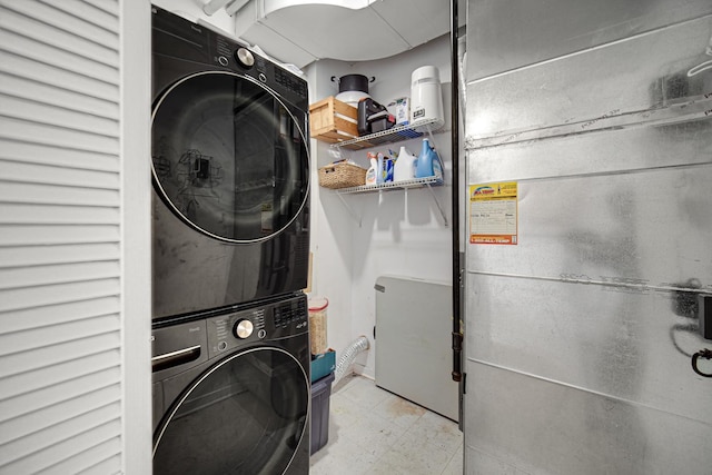 laundry room with heating unit, tile patterned floors, laundry area, and stacked washer and dryer