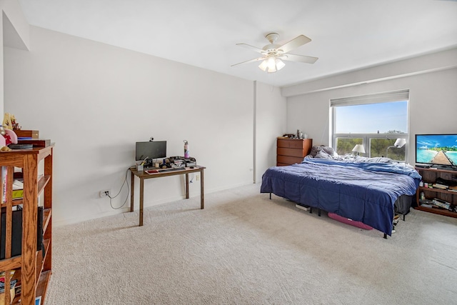 bedroom with a ceiling fan and carpet