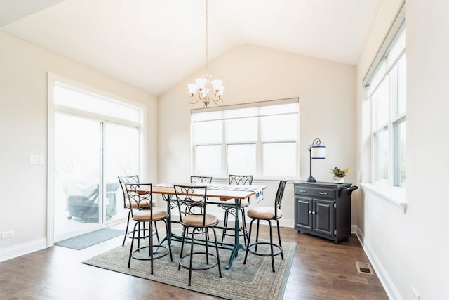 dining area with lofted ceiling, dark wood-type flooring, visible vents, an inviting chandelier, and baseboards