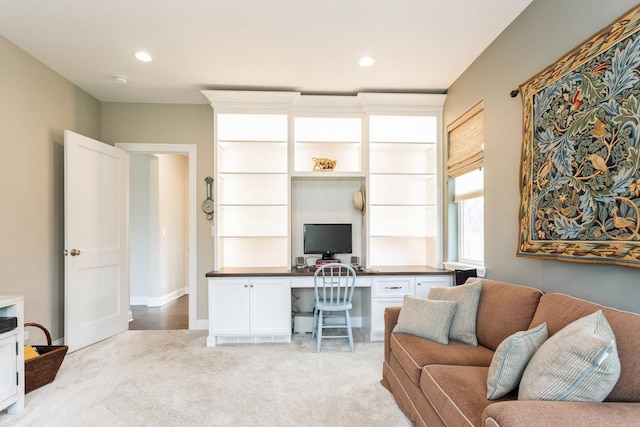 office space featuring built in desk, light carpet, baseboards, and recessed lighting