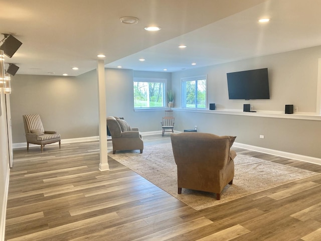 living area with wood finished floors, baseboards, and recessed lighting