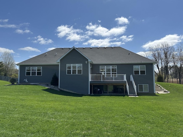 rear view of property with a yard, a deck, and stairway