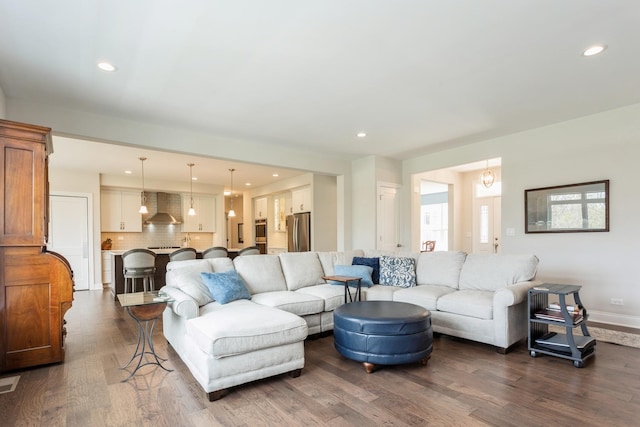 living area with recessed lighting, visible vents, baseboards, and dark wood-style floors
