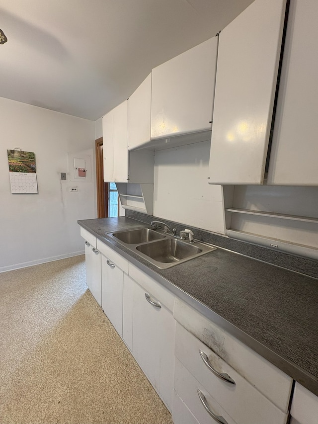 3506 Louis St, Franklin Park, IL 60131 - kitchen featuring a sink, dark countertops, white cabinets, and baseboards