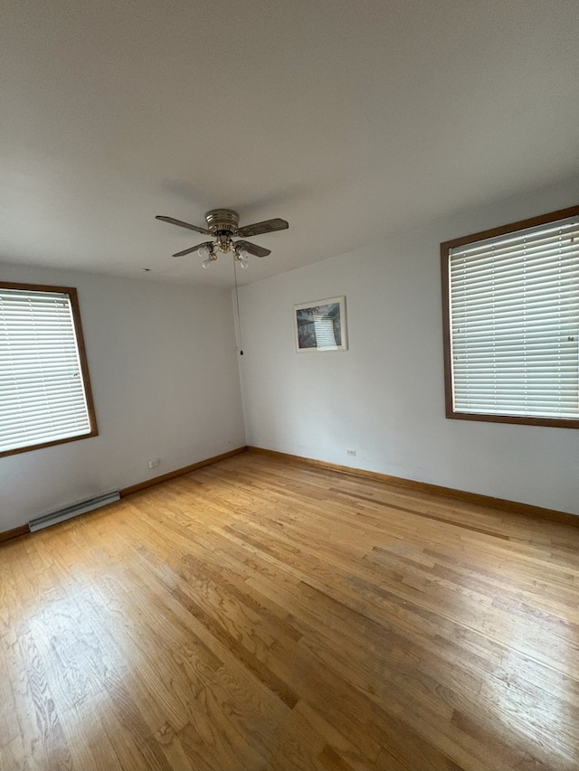 3506 Louis St, Franklin Park, IL 60131 - spare room featuring a baseboard radiator, light wood finished floors, ceiling fan, and baseboards
