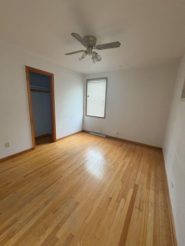 3506 Louis St, Franklin Park, IL 60131 - unfurnished bedroom with light wood-type flooring, baseboard heating, baseboards, ceiling fan, and a closet