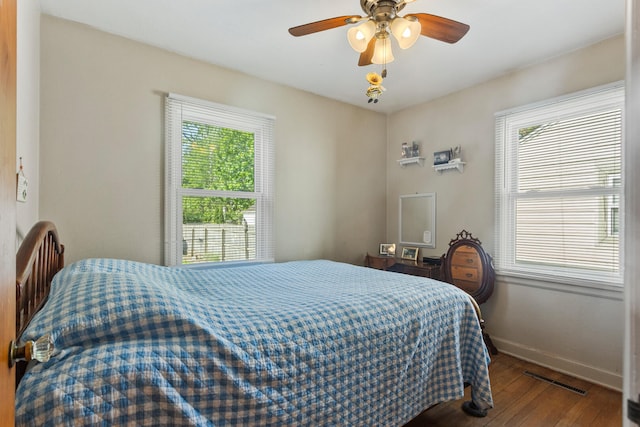 bedroom featuring hardwood / wood-style floors, baseboards, and a ceiling fan