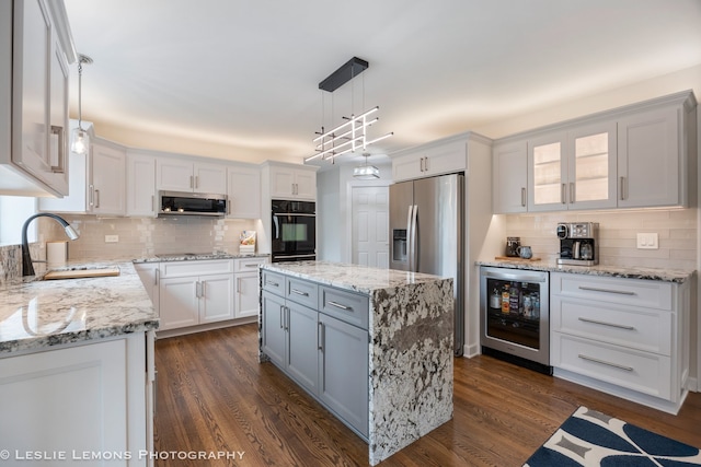 kitchen featuring wine cooler, black appliances, decorative backsplash, a sink, and white cabinets
