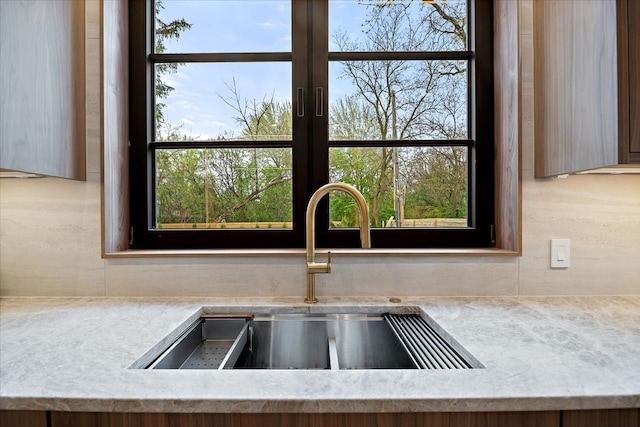 interior details with backsplash and a sink