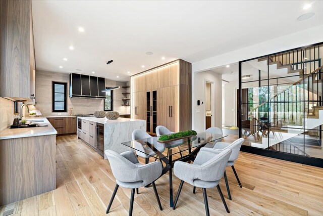 dining area featuring visible vents, stairway, light wood finished floors, beverage cooler, and recessed lighting