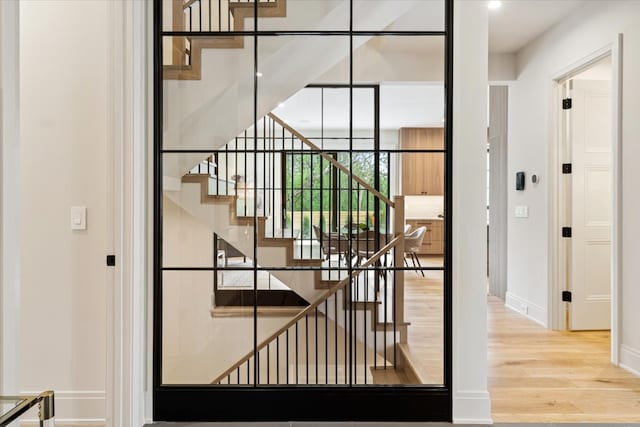 stairway featuring baseboards and wood finished floors