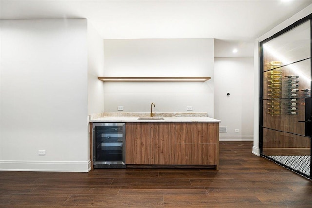 bar with wine cooler, wet bar, dark wood-style floors, and a sink
