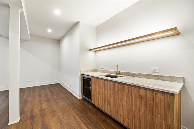 bar with indoor wet bar, a sink, dark wood-style flooring, and wine cooler