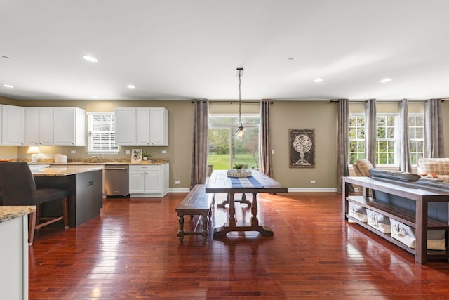 kitchen with white cabinets, dark wood-style flooring, baseboards, and dishwasher