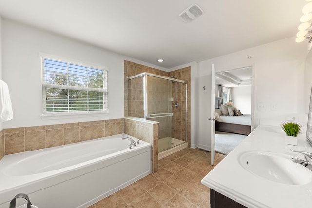 full bathroom with double vanity, a bath, visible vents, a shower stall, and a sink