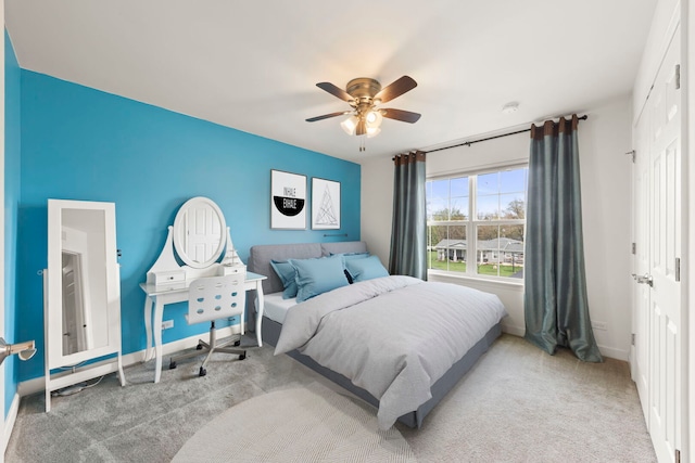 carpeted bedroom with baseboards and a ceiling fan
