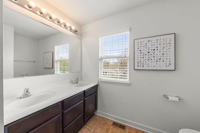 full bathroom with visible vents, a sink, baseboards, and double vanity