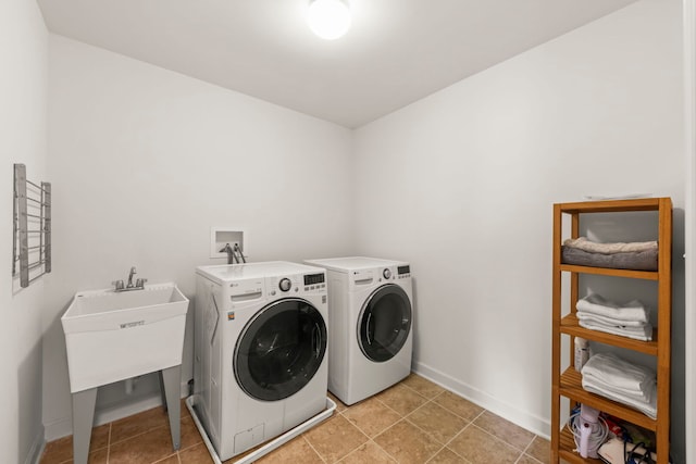 laundry area featuring baseboards, laundry area, and washing machine and clothes dryer