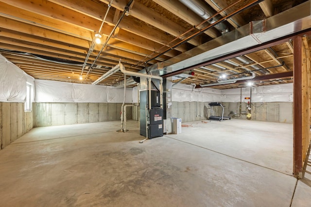 unfinished below grade area featuring heating unit