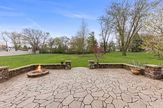 view of patio with a fire pit and fence