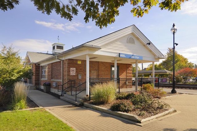 view of front of house with a porch and brick siding