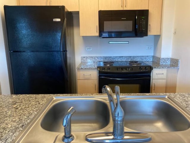 1740 Oak Ave Unit 307, Evanston, IL 60201 - kitchen with a sink, light brown cabinetry, black appliances, and light stone countertops