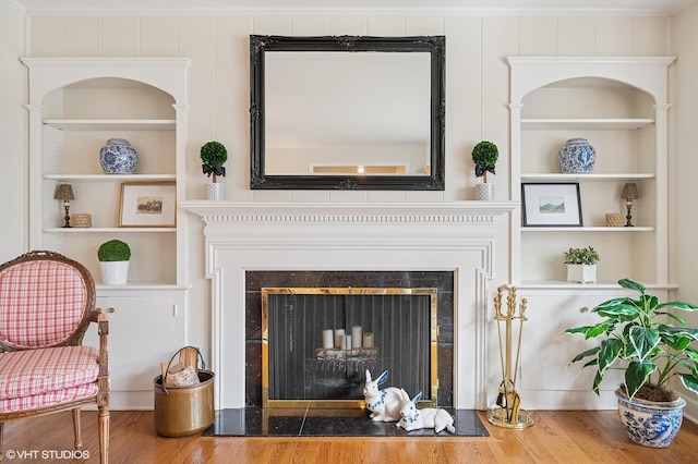interior space with a fireplace with flush hearth and built in features
