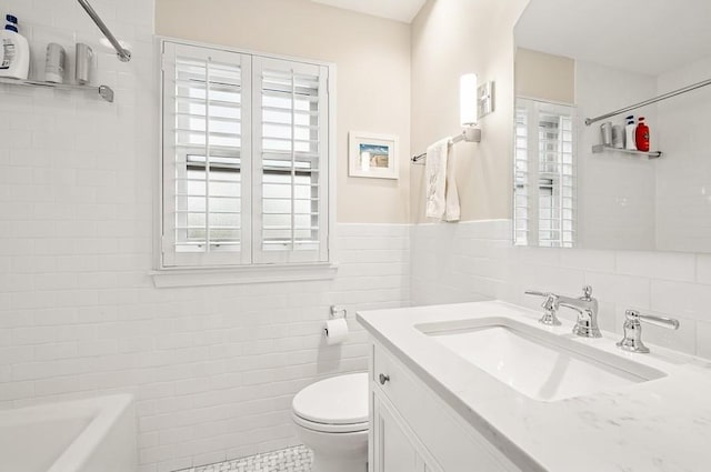 full bath featuring tile patterned flooring, tile walls, toilet, and vanity