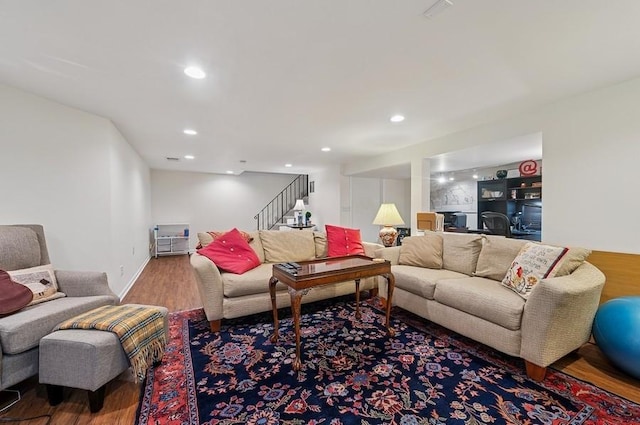 living room with stairs, baseboards, recessed lighting, and wood finished floors