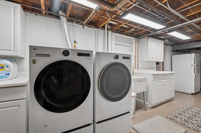 laundry room featuring separate washer and dryer and cabinet space