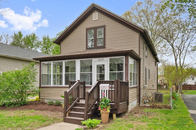 view of front of property featuring fence and cooling unit