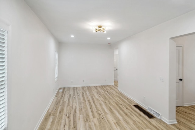 unfurnished room with visible vents, recessed lighting, light wood-style floors, and baseboards