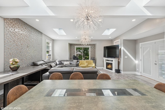 11330 Brigitte Ter, Orland Park, IL 60462 - living area featuring a skylight, a chandelier, recessed lighting, a lit fireplace, and baseboards