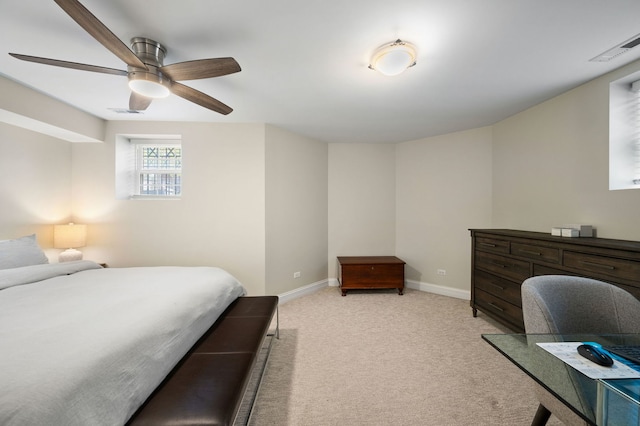 bedroom with light colored carpet, baseboards, an office area, and ceiling fan