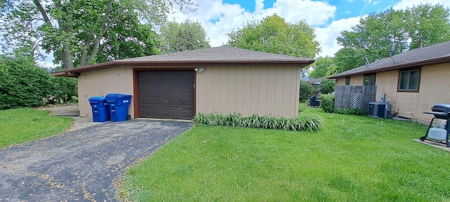detached garage featuring central AC unit and driveway