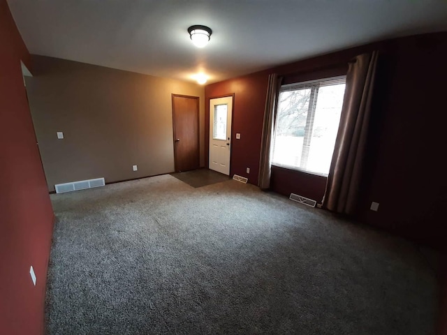 carpeted spare room with visible vents