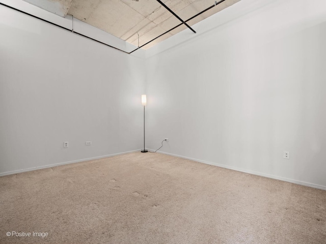 empty room with baseboards and carpet flooring