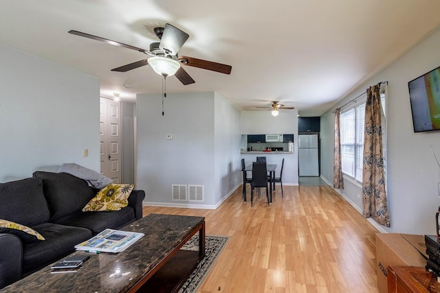 509 Darlene Ln Unit A, Glendale Heights, IL 60139 - living room with a ceiling fan, light wood-style floors, and baseboards