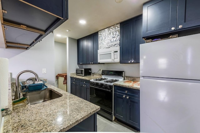 kitchen with light stone counters, a sink, white appliances, recessed lighting, and blue cabinets