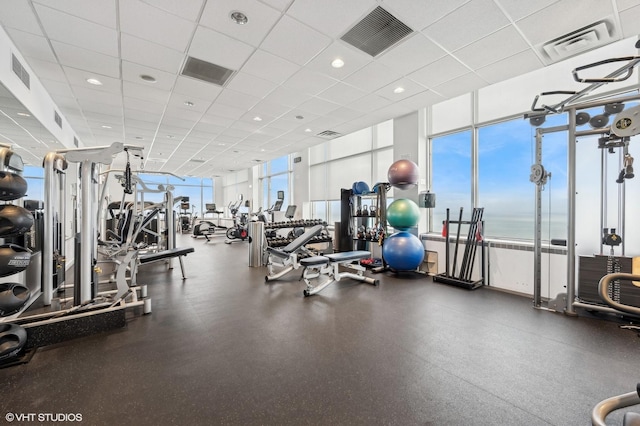 exercise room with a drop ceiling and visible vents