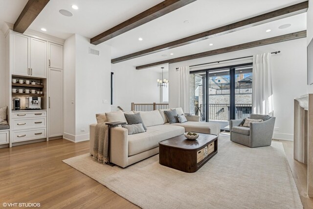 1934 W Patterson Ave, Chicago, IL 60613 - living room featuring light wood-style floors, beam ceiling, baseboards, recessed lighting, and a chandelier