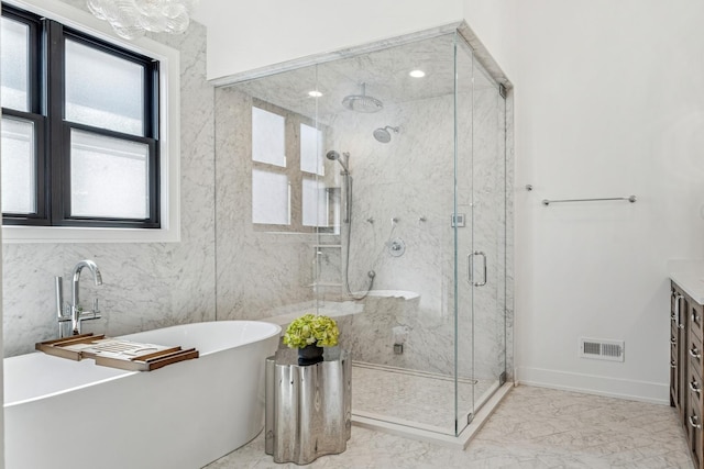 1934 W Patterson Ave, Chicago, IL 60613 - bathroom featuring marble finish flooring, a stall shower, a soaking tub, vanity, and baseboards