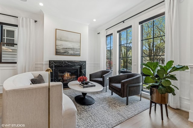 1934 W Patterson Ave, Chicago, IL 60613 - living area with a decorative wall, wood finished floors, a fireplace, a wainscoted wall, and recessed lighting