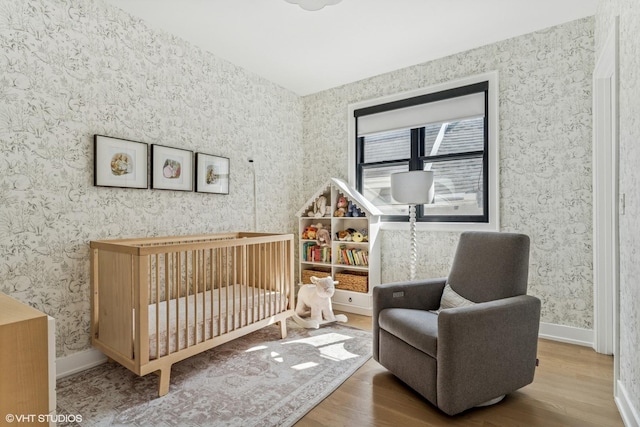 1934 W Patterson Ave, Chicago, IL 60613 - bedroom featuring wood finished floors, wallpapered walls, a nursery area, and baseboards