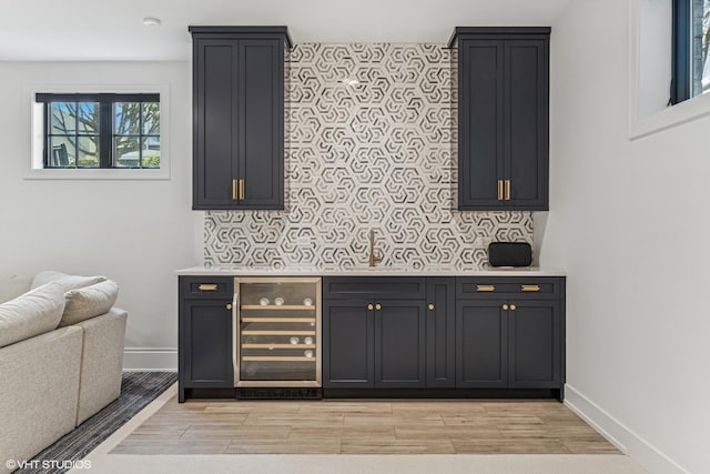 1934 W Patterson Ave, Chicago, IL 60613 - indoor dry bar featuring wine cooler, light wood finished floors, baseboards, and wallpapered walls